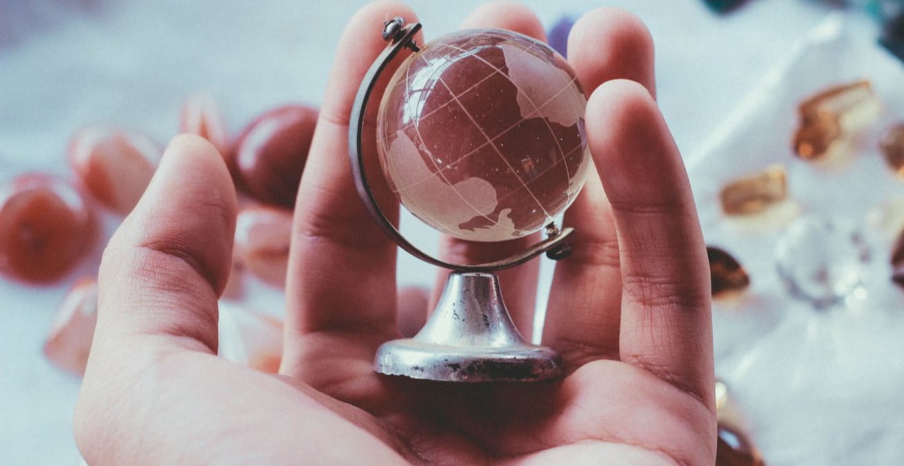glass globe in hand as proxy for boost sales on amazon going global
