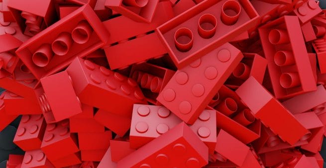 red lego bricks randomly scattered as proxy for be creative 