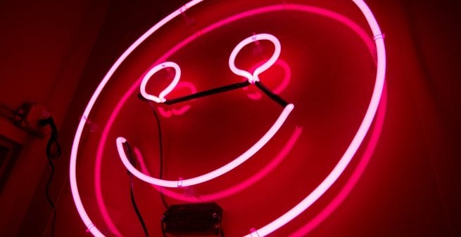 red neon smiley face as proxy for have fun purpose of blogging